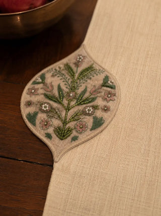 Close-up of hand-stitched glass beads, silk embroidery and pearls on linen