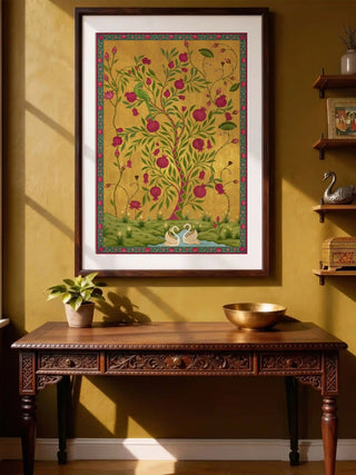 Mughal garden wall art with a pomegranate tree and swans on gold, framed above a wooden console
