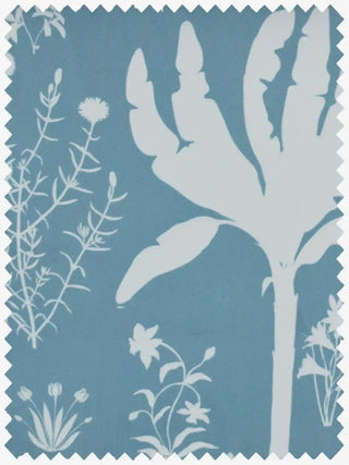 A close-up of the soft folds of Flora n Fauna blue velvet fabric showing the white illustrative details of cranes and wildflowers.