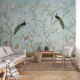 A full view of the Bagliya Peacock Chinoiserie wallpaper mural, showing the entire scene with peacocks, birds, and pink blossoms.