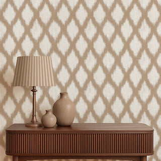 Decorative table with lamp and vases against a patterned wallpaper.
