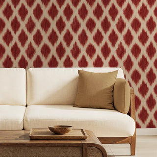 Classic Indian Ikat Pattern Wallpaper, Red, Beige sofa with a brown pillow against a red and white patterned wall.