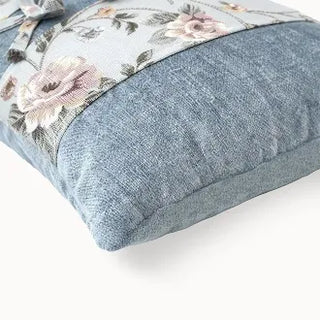 Close-up of blue velvet and floral fabric texture.