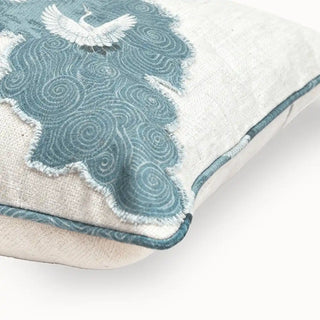 The Graceful Cranes Patch Cushion Cover: closeup view of a cushion featuring cranes over a blue panel. The mix of natural linen and patchwork gives it a refined, contemporary appeal.