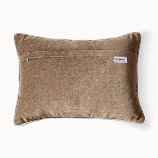 Back view of cushion showing zipper and velvet texture.