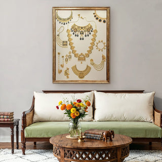 Jewels of Nizam embroidered wall art displayed above a classic wooden sofa, showcasing intricate gold jewelry motifs inspired by regal Nizami heritage.
