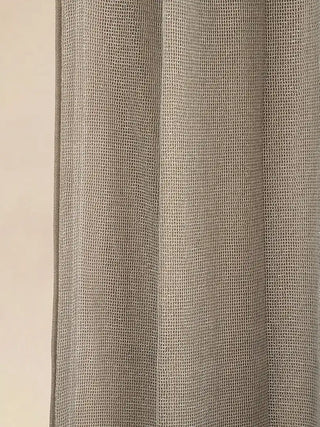 Kanan Readymade Curtain readymade curtain, macro shot focusing entirely on the side border's unique fabric. It reveals an intricate, open-weave grid pattern in the mesh. The solid fabric backing is faintly visible be...