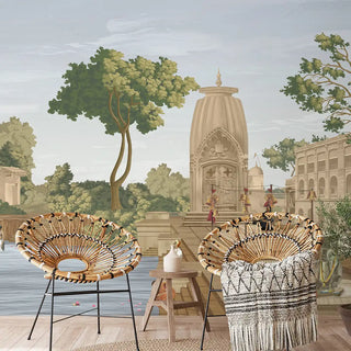 Decorative chairs with woven designs in front of a wall mural of an ancient temple and trees.