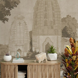 Decorative setting with a wooden console table, plants, and a mural of architectural elements on the wallpaper