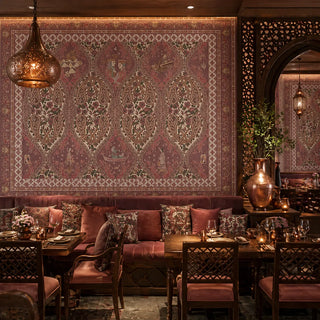 The Kashmiriyat Indian Style Wallpaper mural, showing a full view of the Mughal-inspired pattern with a central motif featuring birds, flowers, and a detailed frame. view-restaurants