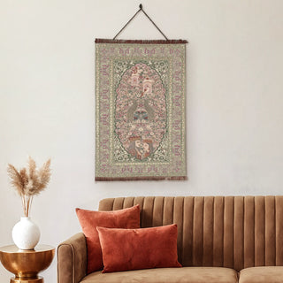 Kashmiriyat embroidered wall art hanging above a brown velvet sofa, showcasing intricate Kashmiri craftsmanship in pastel tones.