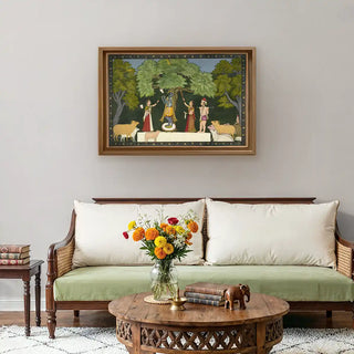 Krishna Leela with Gopies Vintage Indian Wall Art framed above a classic wooden sofa with neutral cushions, blending traditional spirituality with modern home style.