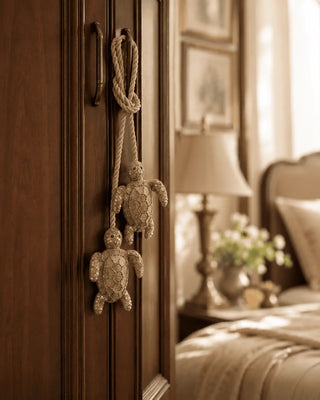 Beaded Kurma turtle charm hanging from a bedroom wardrobe handle