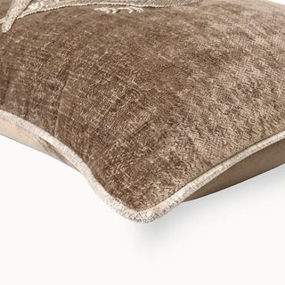 Close-up of crushed taupe velvet fabric and piping detail.