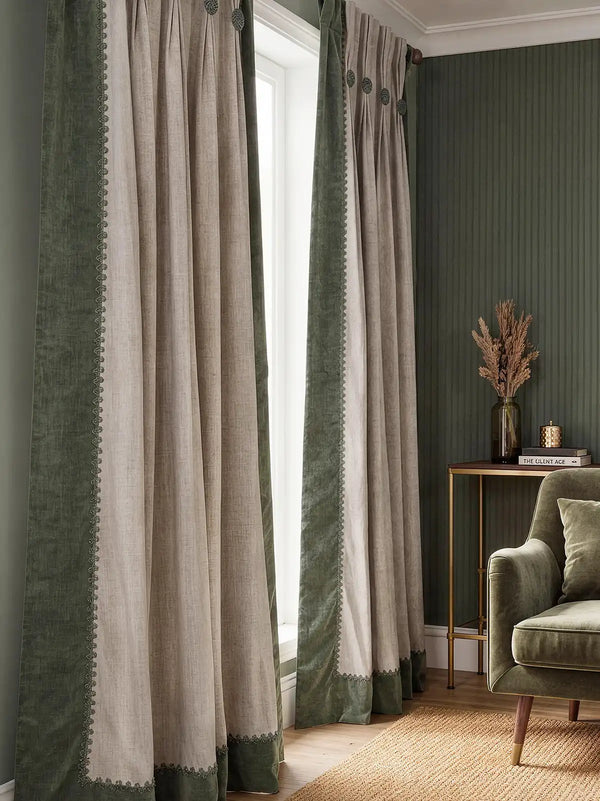 pair of Olivia curtains framing a window in a sophisticated room with fluted green walls and velvet furniture.