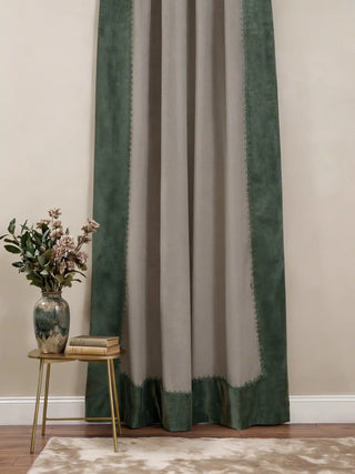 full-length view of the Olivia curtain featuring oatmeal linen, forest green velvet borders, and braided trim styled in a neutral room.