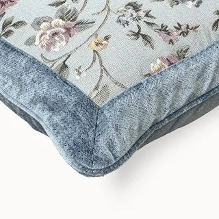 Close-up of blue floral cushion's rope trim and corner.