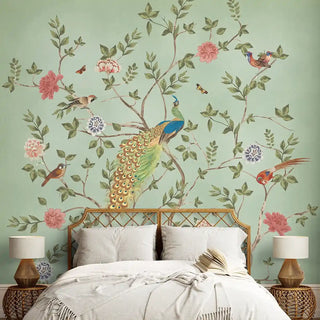 A decorative wallpaper inside a living room archway. The mural features a peacock, birds, and blooming branches on a pastel green background in a bedroom setup.
