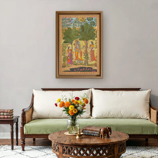 Raga Rama Vintage Indian Wall Art framed above a classic wooden sofa with neutral cushions and a floral centerpiece, bringing heritage artistry to elegant interiors.