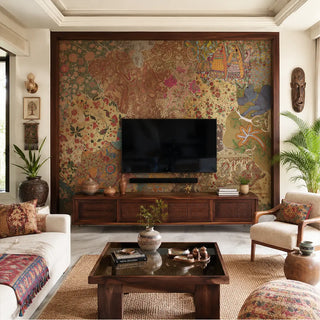 The Rang Rali collection is a vibrant celebration of heritage, featuring an Indian-inspired wallpaper that artfully patches together the diverse textile traditions of India. This rich, tapestry-like backdrop is anchored by a dark mahogany-finish TV console with intricate cane-webbing detail, grounding the maximalist art with earthy, natural textures. view-tvpanel