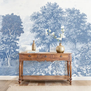 Saanjh Blue Wallpaper: Full mural installation of the blue and white detailed forest landscape in an entryway with a console table.