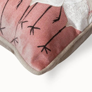 Sedge Pink Cushion Cover: Closeup view of a cushion featuring embroidered cranes set against a soft pink fabric patch, it pairs beautifully with a warm beige base for a refined, modern contrast.