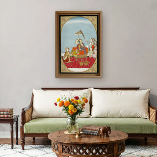 Shri Ram Parivar Indian Painting Wall Art displayed above a traditional sofa with floral accents, blending heritage craftsmanship with warm, devotional charm.