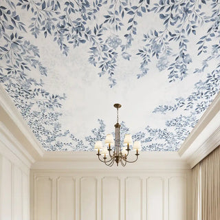 A sophisticated ceiling wallpaper featuring soft blue botanical motifs on a white background, creating a serene orchard-inspired canopy above a classic chandelier setting.