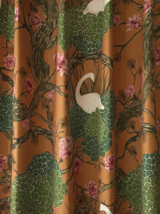 Silk Route Readymade Curtain in Ochre and Sage readymade curtain, focused, flat-lay view of the central repeating pattern. The rich, warm ochre background highlights a captivating, vintage-inspired scene featuring el...