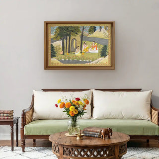 Story of Rama Wall Art displayed above a wooden sofa with neutral cushions and marigold flowers, blending mythological charm with modern decor.