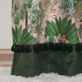 Bottom detail of Tropical Tales Readymade Curtain showcasing green border panel with playful tassel accents and tropical foliage design.