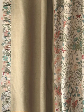 A macro shot focusing on the distinct fabric transitions and textures. It beautifully captures the delicate, vintage-inspired botanical floral print meeting the smooth, solid olive-toned linen panel, which is then elegantly bordered by a gathered, ruffled trim made from the same floral fabric, adding rich tactile depth.