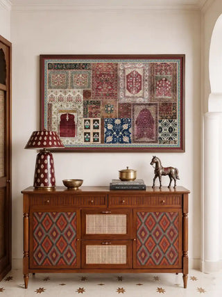 The framed Aalishan wall art displayed above a wooden console table in a foyer, styled with a patterned lamp and brass accents.