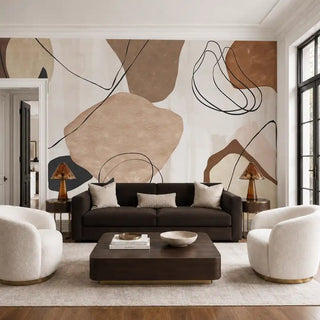 The Abstract Ochre wallpaper installed behind a dark brown sofa and cream boucle armchairs in a living room view-livingroom