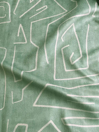 Green sofa fabric with white geometric pattern