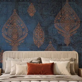 A sophisticated bedroom setting featuring the Afsana Teal Blue mural behind a fluted headboard with terracotta linens.
