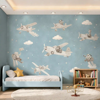 A sophisticated nursery setting featuring the blue aviator animal mural behind a modern blue bed with a star cushion.