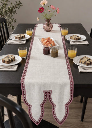 The Amrah Runner in Natural & Mauve centres a dark wood dining table set for breakfast, with loaf cake, orange juice and fruit preserves on either side.