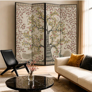 Anant Vriksha Tree of Life kalamkari wallpaper in beige on a four-panel folding screen behind a cream sofa and black lounge chair in a living room