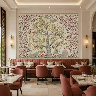Anant Vriksha Tree of Life kalamkari wallpaper in beige framed above a terracotta velvet banquette with marble tables and brass sconces in a restaurant