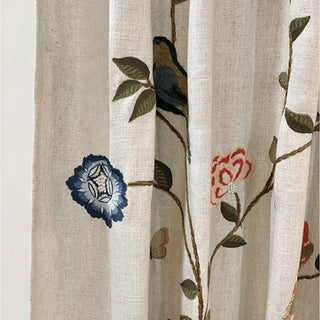 Close-up of Anar Bloom Curtain showing detailed design of a perched blue bird, blooming flowers, and leafy vines.
