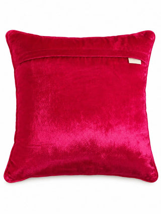 The reverse of the Anarkali cushion cover in plain fuchsia velvet with an overlap closure, pink piping and a woven brand label.