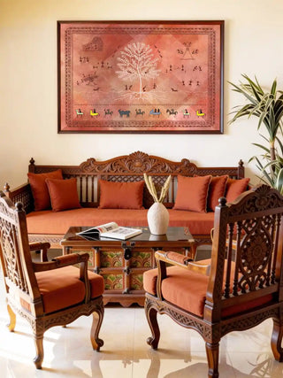 A framed Ancient Warli art piece styled above a wooden sideboard with brass accents.