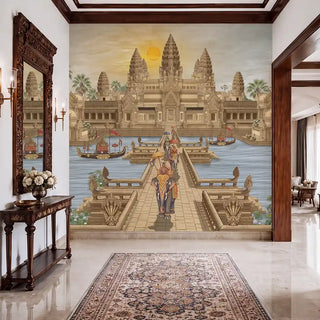 The Angkor Wat wallpaper mural in Gold & Sepia installed on a feature wall in an entryway, depicting the temple at sunset with a ceremonial elephant procession crossing the causeway. view-foyer