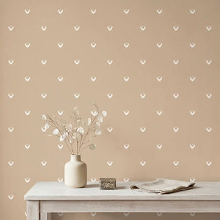 A serene bedroom setting featuring the Anuraag wallpaper behind a neutral boucle headboard and a wooden side table.