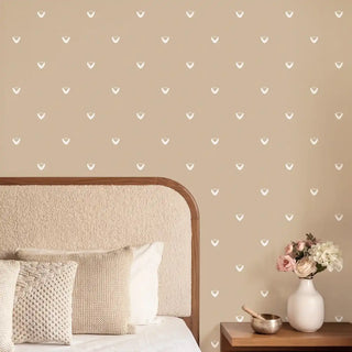 A luxury hallway setting featuring the Anuraag wallpaper behind a rustic white console table with artisanal decor.