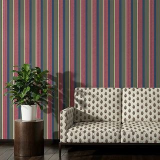 Sofa upholstered in Arang Fabric, paired with striped wallpaper in earthy tones.