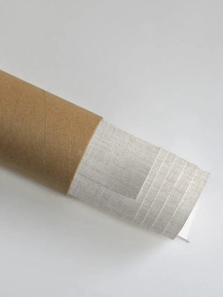 High-quality archival canvas material for the Arches of Ascent print shown rolled safely inside a durable shipping tube.