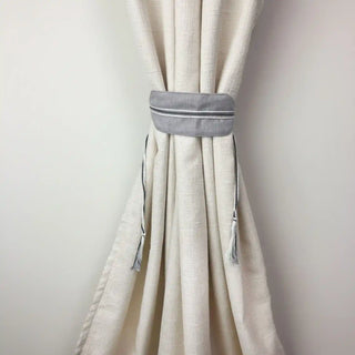 Ashline Geometric Curtain Tieback secured around a thick, textured cream curtain, demonstrating its function and modern aesthetic.