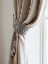 Off white curtain with a decorative ashline tieback  by lifencolors in a living room setting